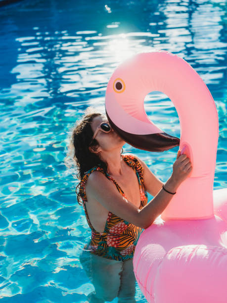 istock Woman with flamingo inflatable during vacation 926579978
