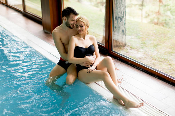 istock Loving couple relaxing in the spa by pool 926588400