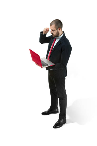 istock Picture of handsome young bearded man standing over white studio background with laptop 926590568