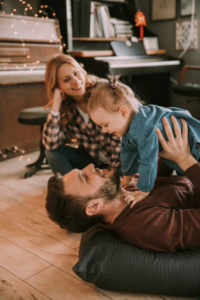 istock Happy young family playing on the floor 926594794