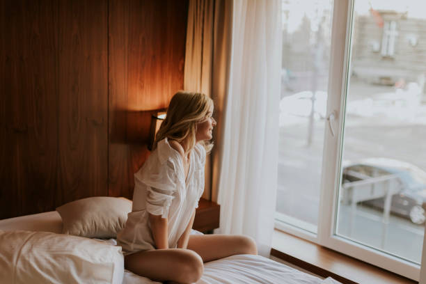 istock Young woman sitting on the bed 926595464