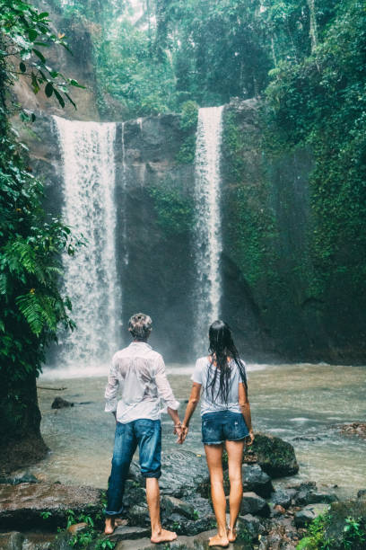 istock Mature couple standing near waterfall 926597830