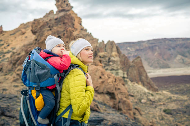istock Family hike, mother with baby in backpack 926597900