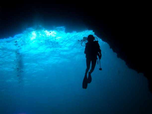 istock silhouette diver in a cave, koh tao island, thailand 926598868