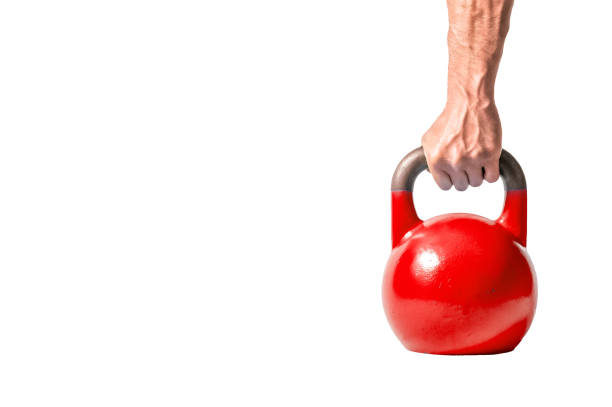 istock Strong muscular man hand with muscles holding red heavy kettlebell partially isolated on white background 926598884