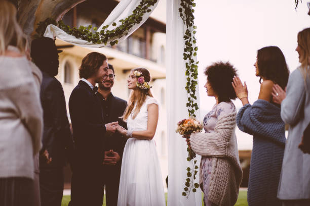istock Happy bride and groom getting married at outdoors wedding ceremony 926599160