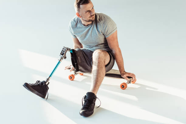 istock man with leg prosthesis sitting on skateboard 926601844