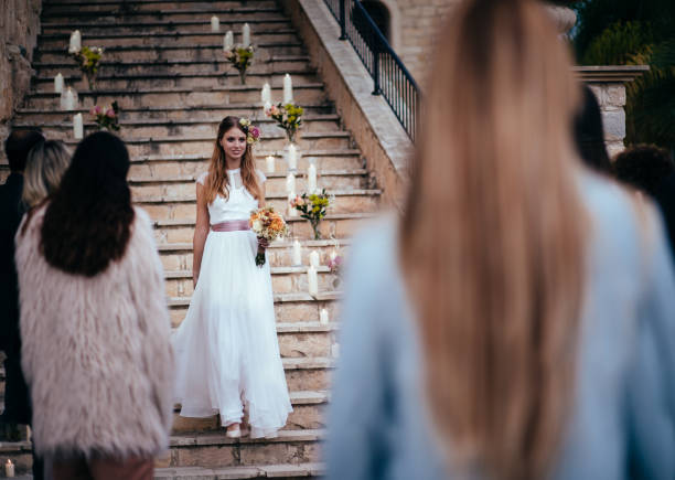 istock Beautiful happy bride walking down stone steps at wedding ceremony 926602030