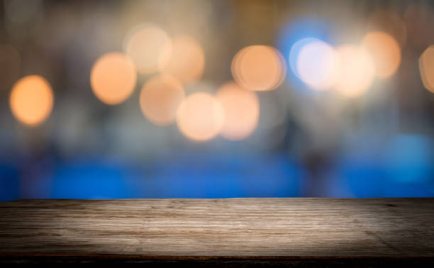 istock Wood table top on shiny bokeh gold background, vintage tone 926602602