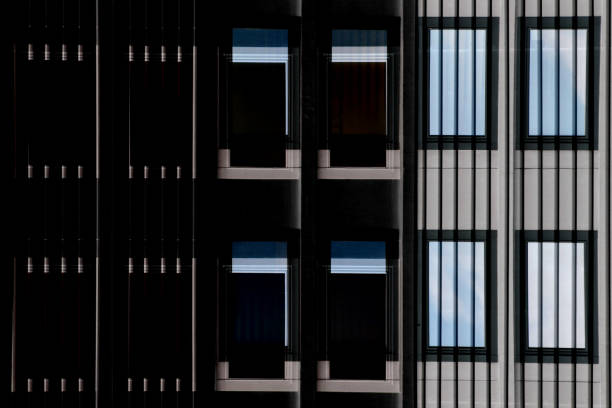 istock Modern architecture by day and by night. Grid structures. Digitally rendered image of industrial or office building fragment with two rows of dark and light windows. 926602888