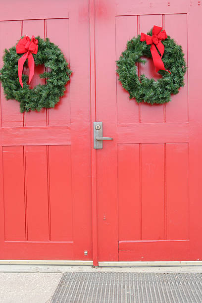 istock Red door with twin Christmas wreaths 92660363