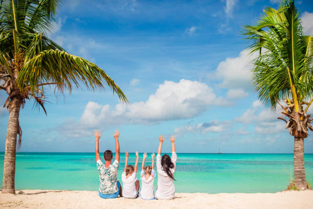 istock Happy family on beach vacation raised their hands 926605370