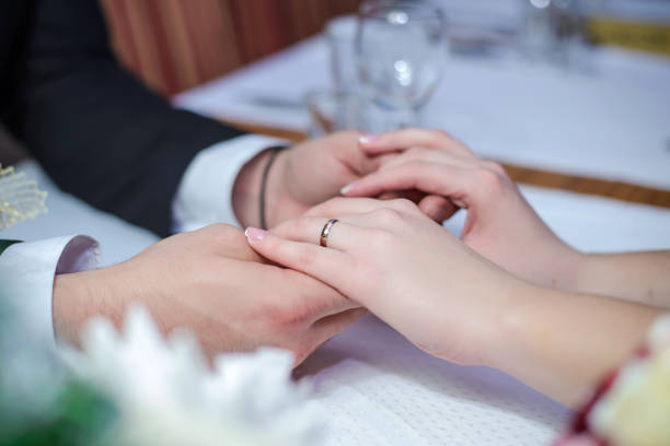 istock Couple in love holding hands at the table 926606278