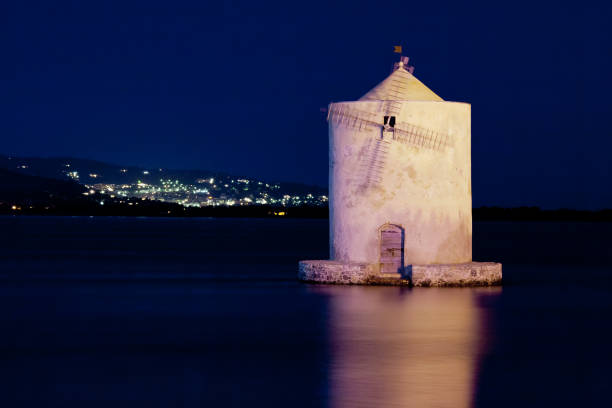 Old windmill near Porto Santo Stefano at night, Italy stock photo