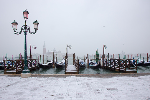 Venice in snow with gondolas on St. Mark square, snowing in Venice, Italy, march 2018