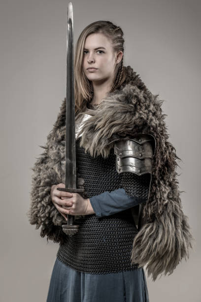 istock Blond braided weapon wielding viking warrior female alone in studio shoot 926613708