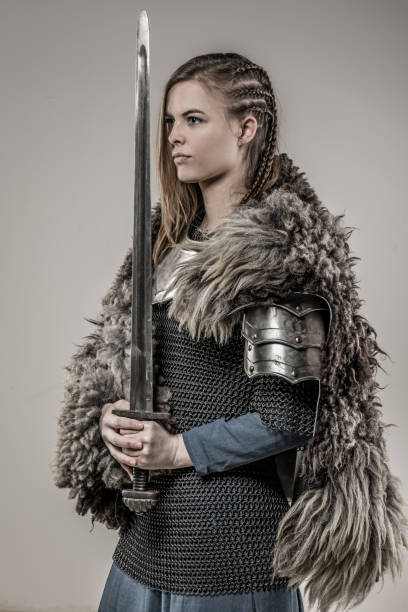 istock Blond braided weapon wielding viking warrior female alone in studio shoot 926613710