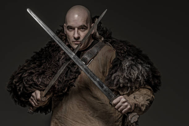 istock Shaved head weapon wielding bloody viking warrior soldier alone in studio shoot 926613898