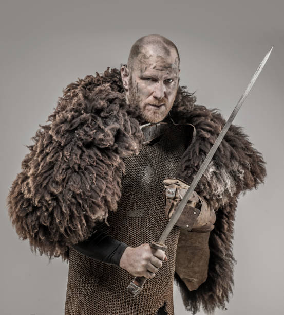 istock Shaved head weapon wielding bloody viking warrior soldier alone in studio shoot 926613910