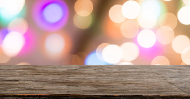 istock Rrustic wood table in front of glitter and bright bokeh lights 926613914