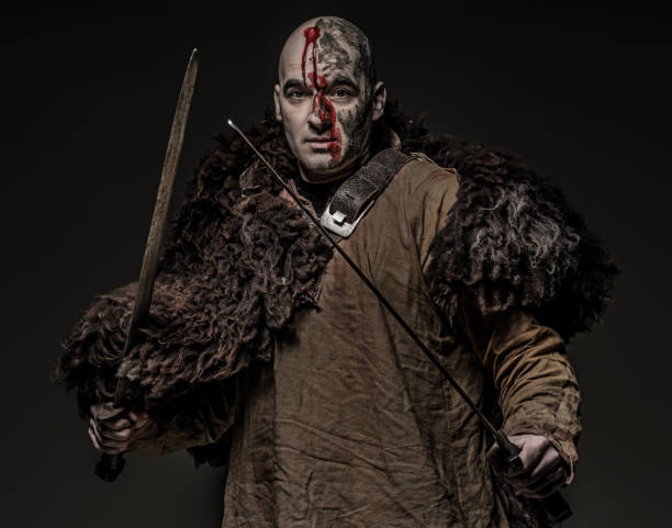 istock Shaved head weapon wielding bloody viking warrior soldier alone in studio shoot 926613968