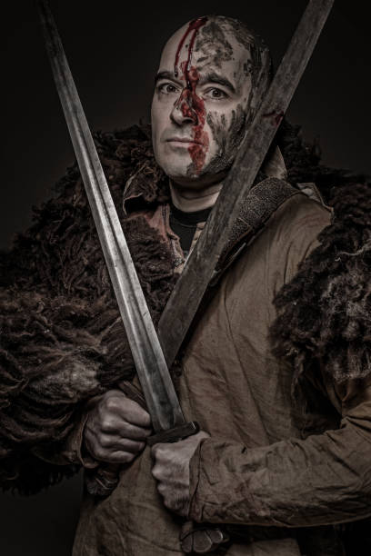 istock Shaved head weapon wielding bloody viking warrior soldier alone in studio shoot 926614066