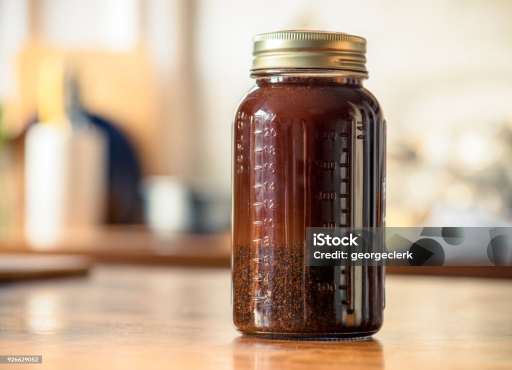 Making cold brew coffee at home Cold-brew coffee making using the immersion method, where the ground coffee is left in a jar with water while the coffee brews. Cold Brew Coffee Stock Photo