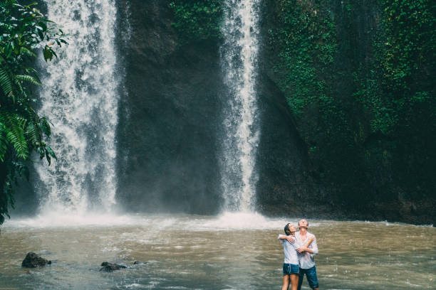 istock Mature couple standing near waterfall 926633002