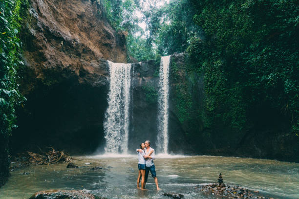 istock Mature couple standing near waterfall 926633360