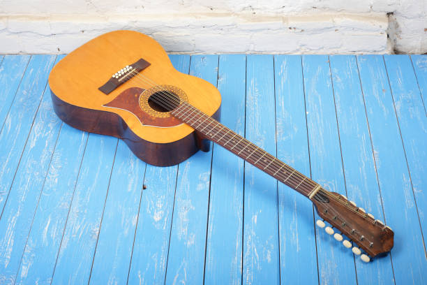 istock Musical instrument - Twelve-string acoustic guitar brick background 926637526