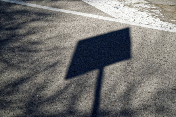Shadow street sign on asphalt road, urban background Shadow street sign on asphalt road, urban background. elefant stock pictures, royalty-free photos & images