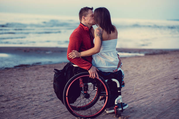 istock Handicapped couple resting on a beach. 926644270