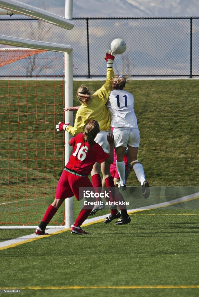 Female Soccer Players Compete for Airborne Ball at Far Post  Physical Injury Stock Photo