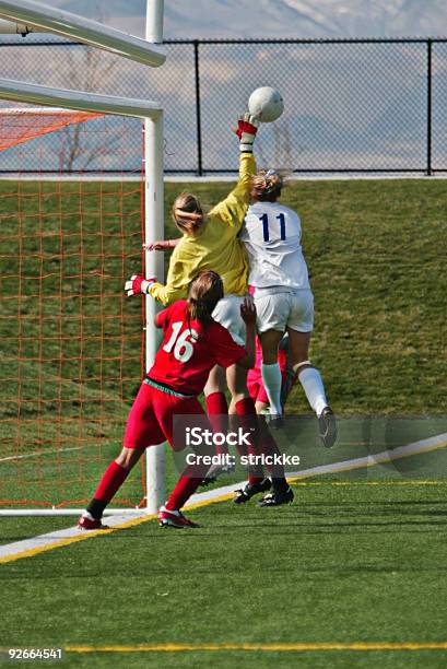 Female Soccer Players Compete For Airborne Ball At Far Post Stock Photo - Download Image Now