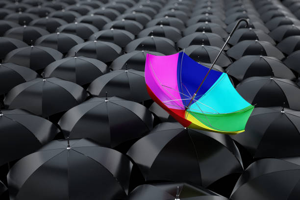 istock Multi colored umbrella stands out among black umbrellas 926645848