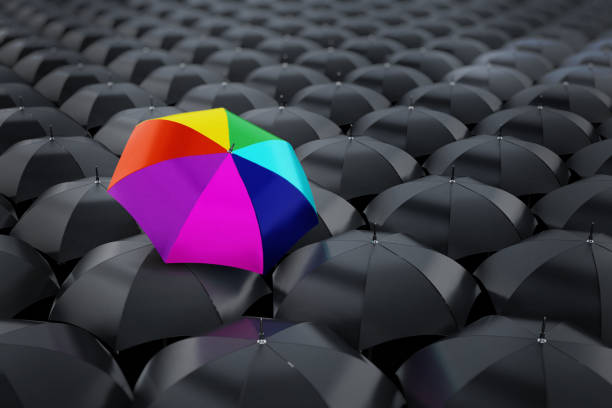 istock Multi colored umbrella stands out among black umbrellas 926648258