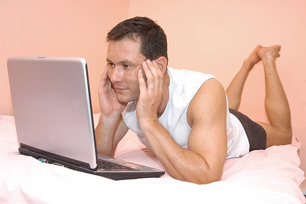 Working in bed stock photo