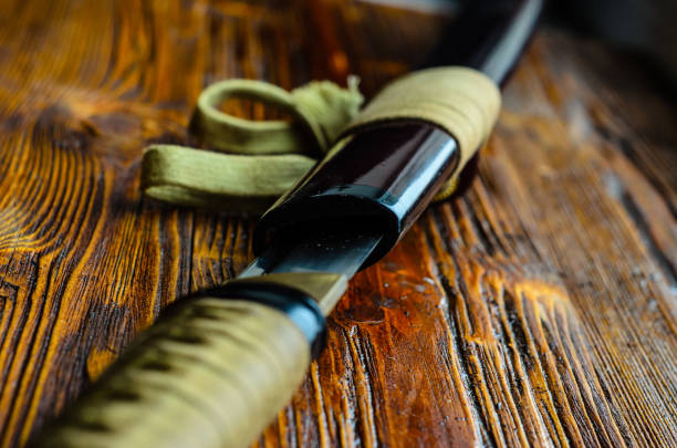 istock Japanese sword katana on wooden background 926650284