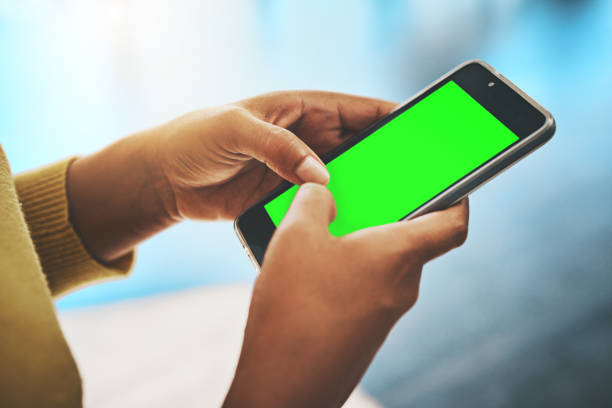 Cropped shot of a businesswoman using a mobile phone in an office