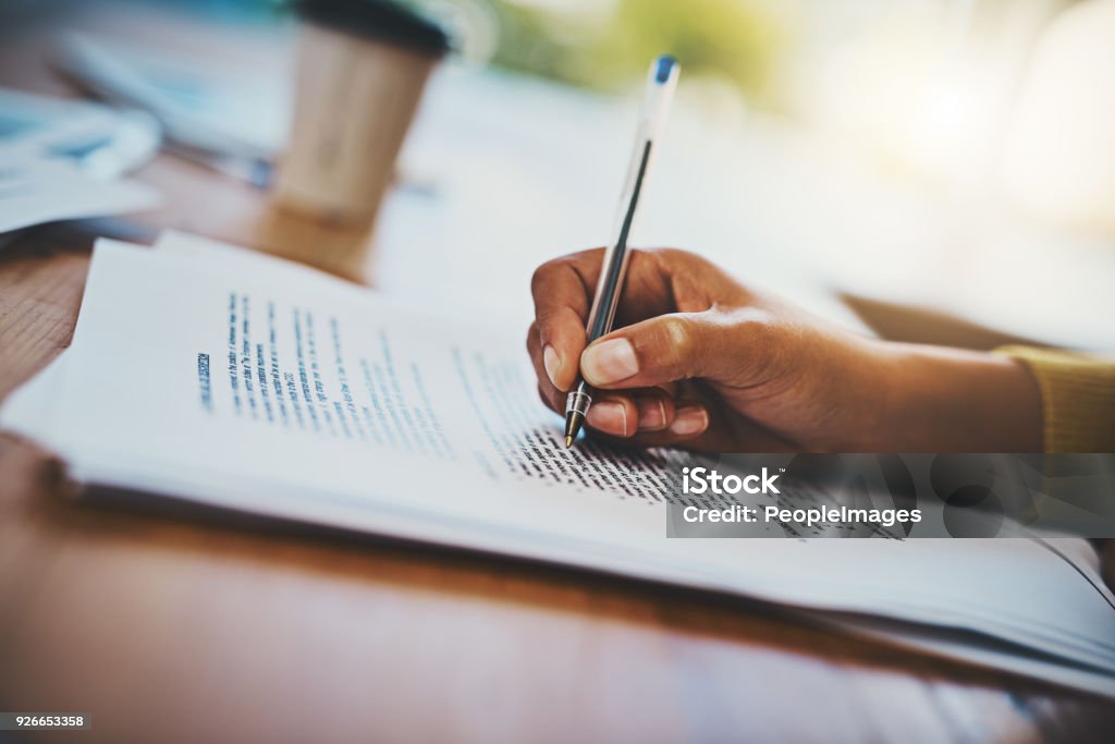 She's got month end reporting down to a fine art Cropped shot of a businesswoman completing paperwork at a desk Signing Stock Photo