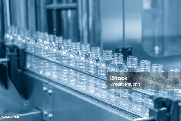 The Plastic Bottle In The Conveyer At The Water Drinking Factory Stock Photo - Download Image Now