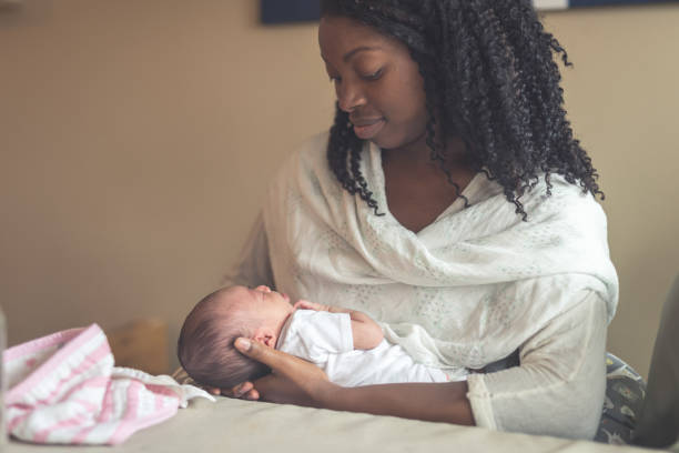 istock New Mom Holding Infant Daughter 926657592