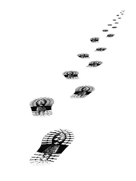 Shoes print on asphalt ground. Sneakers step black mark. Shoe prints on the wall. Human footprints. Footwear steps. Textured dirty wet sole. Minimalist concept. Top view. Close up. Copy space