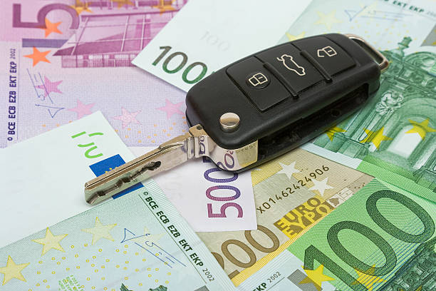 Car key sitting on European banknotes of various amounts stock photo