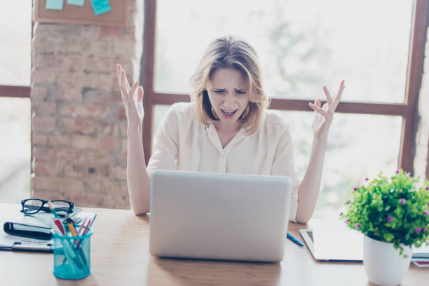 istock Something went wrong! Portrait of sad disappointed young worker, she has problems with her new project, she is sitting at the table 926660842