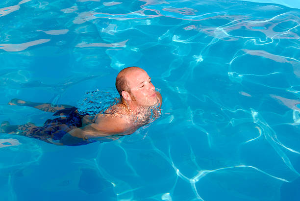 Male in outdoor swimming pool stock photo