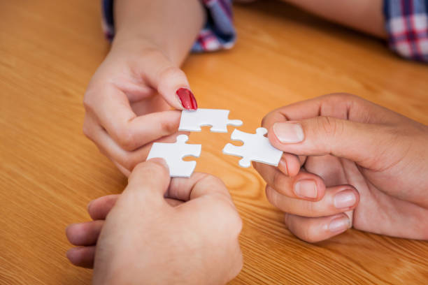 istock Group of business people assembling jigsaw puzzle and represent team support and help concept, Concept for teamwork Building a success. 926668410