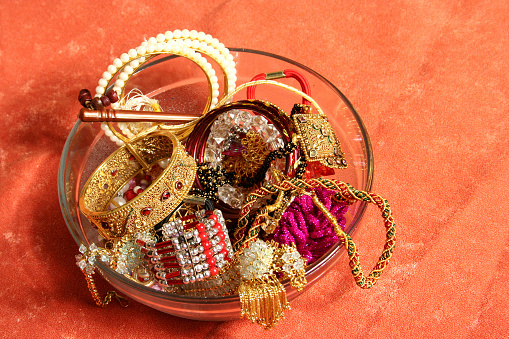 A collection of indian jewellery - gold bangles, pearl bangles, mangal sutra etc.