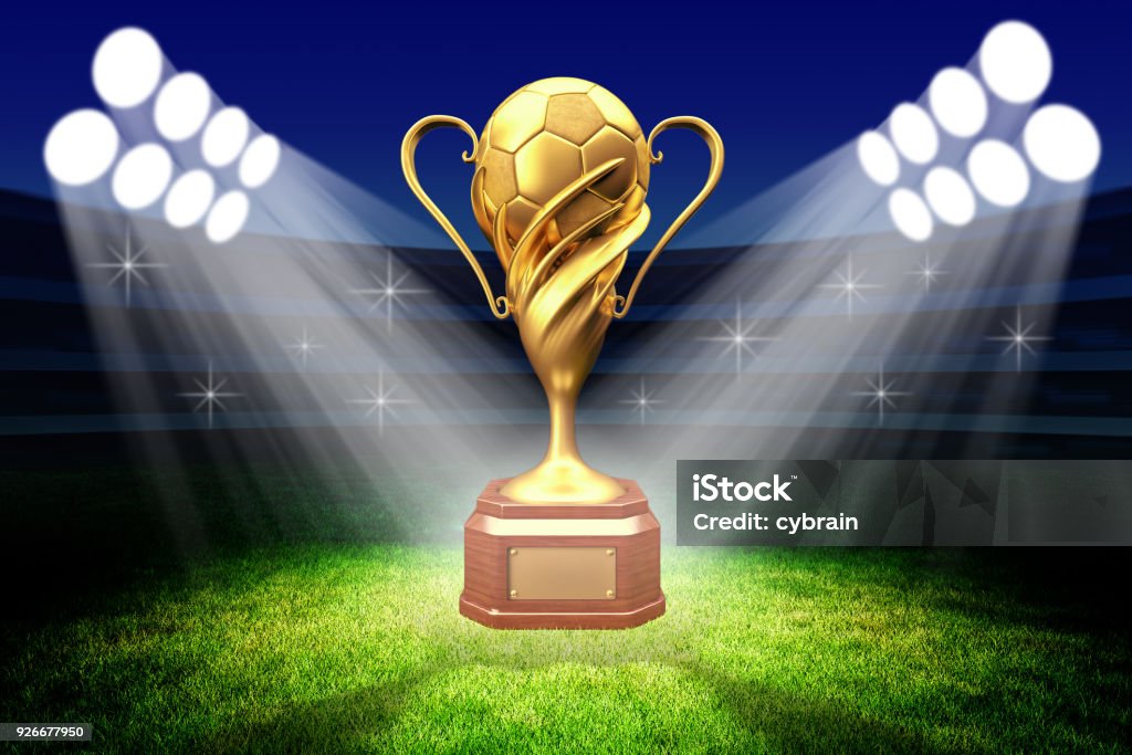 Championship awarding ceremony, gold trophy award Football winner cup with a golden soccer ball in the light of spotlights on the green grass field of the stadium International Soccer Event Stock Photo