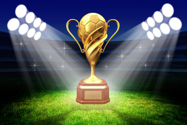 Championship awarding ceremony, gold trophy award Football winner cup with a golden soccer ball in the light of spotlights on the green grass field of the stadium stadium playing field grass fifa world cup stock pictures, royalty-free photos & images